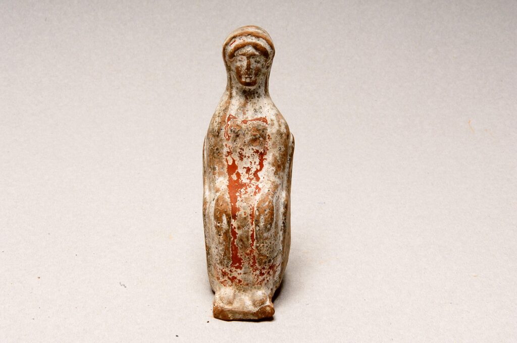 Seated female clay figurine