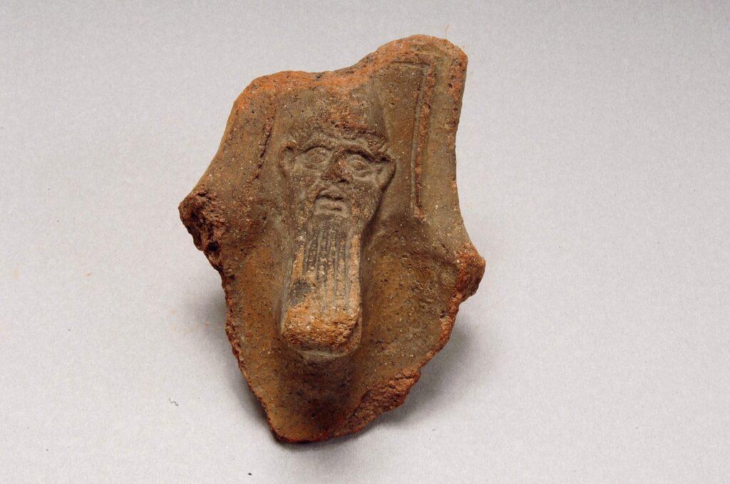 Clay brazier fragment with a bearded figure
