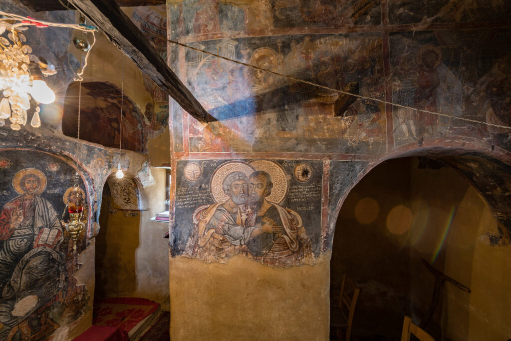 The Church of the Holy Trinity stands in the cemetery of Divri, in the Groustades or Apano Machalas neighbourhood. It is the oldest surviving monument of the village and the wider mountainous area of eastern Ilia. Its history extends from the 14th-century Palaiologan period to Ottoman times. The surviving wall paintings have two layers: the original Late Byzantine decoration of the 14th century and a later Post-Byzantine layer.
