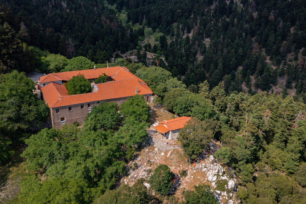 The Monastery of Panagia Chrysopigi, also known as Ano Moni, stands northeast of Divri, modern Lampeia, in the municipality of Ancient Olympia. Its church occupies the south side of the courtyard. It is a single-aisled barrel-vaulted building with a three-sided apse to the east and a narthex to the west. Four chapels surround the church; the chapel of Saints Kyrikos and Ioulitta is entered from the narthex. The almost complete wall-painting cycle dates to 1667, possibly also the year of the church’s construction.