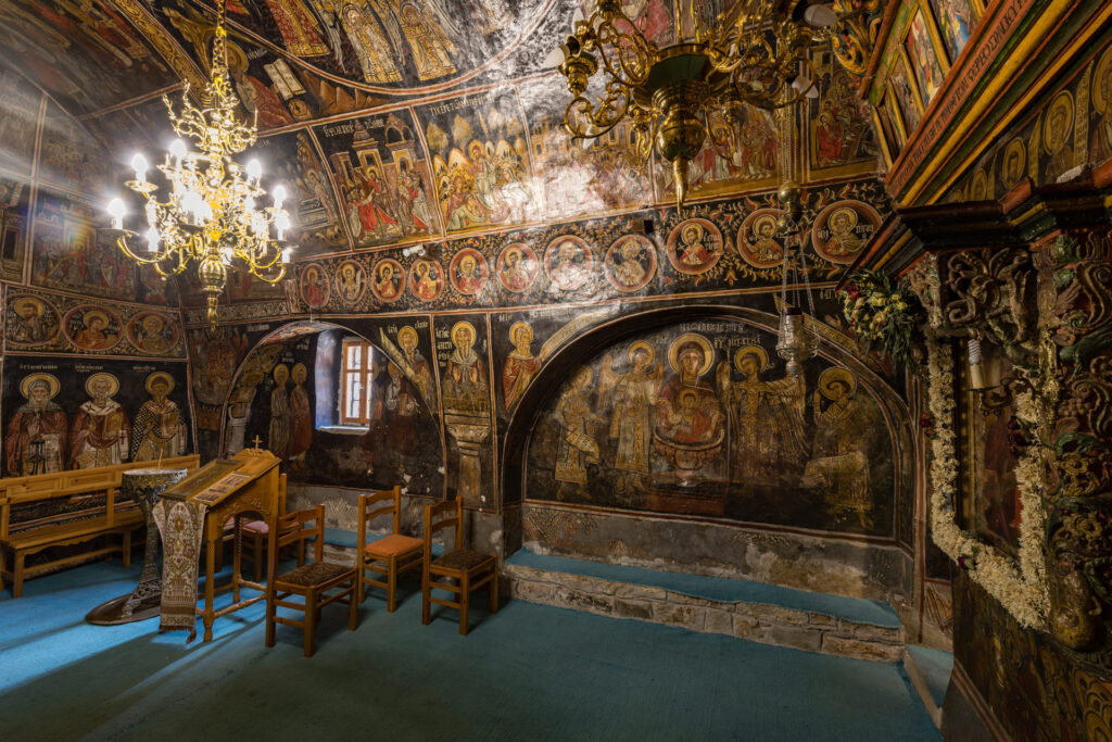 The Monastery of Panagia Chrysopigi, also known as Ano Moni or the Upper Monastery, stands northeast of Divri, modern Lampeia, in the municipality of Ancient Olympia. Its church preserves an almost complete cycle of wall paintings dated 1667; the church itself may also have been built that year.
